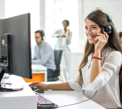 woman on customer service team smiling with headset on